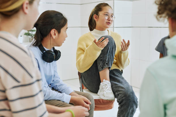 portrait of teenage girl sharing feelings in support group circle for children