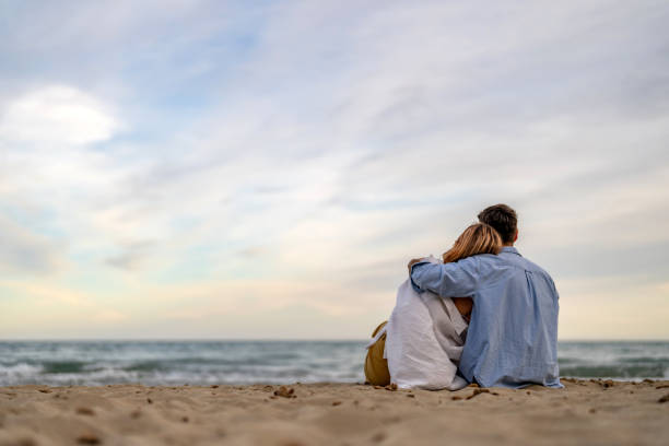 couple looking to the horizon at the shore